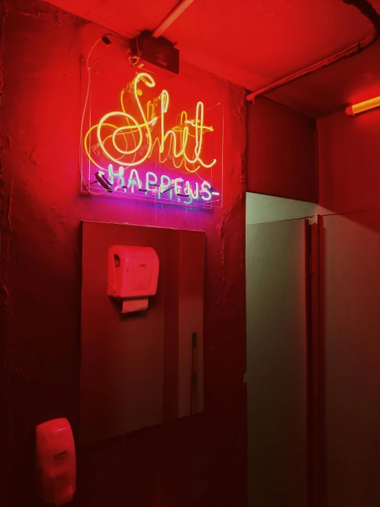 a bathroom with a neon sign on the wall, a photo, inspired by David LaChapelle, trending on unsplash, happening, red light, a still of a happy, shit, pissed off