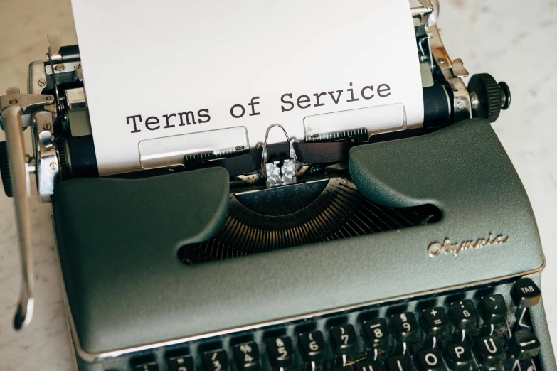 a typewriter with a paper that says terms of service, a cartoon, by Robbie Trevino, unsplash, service ticket close up, high quality photo, thumbnail, cs lewis