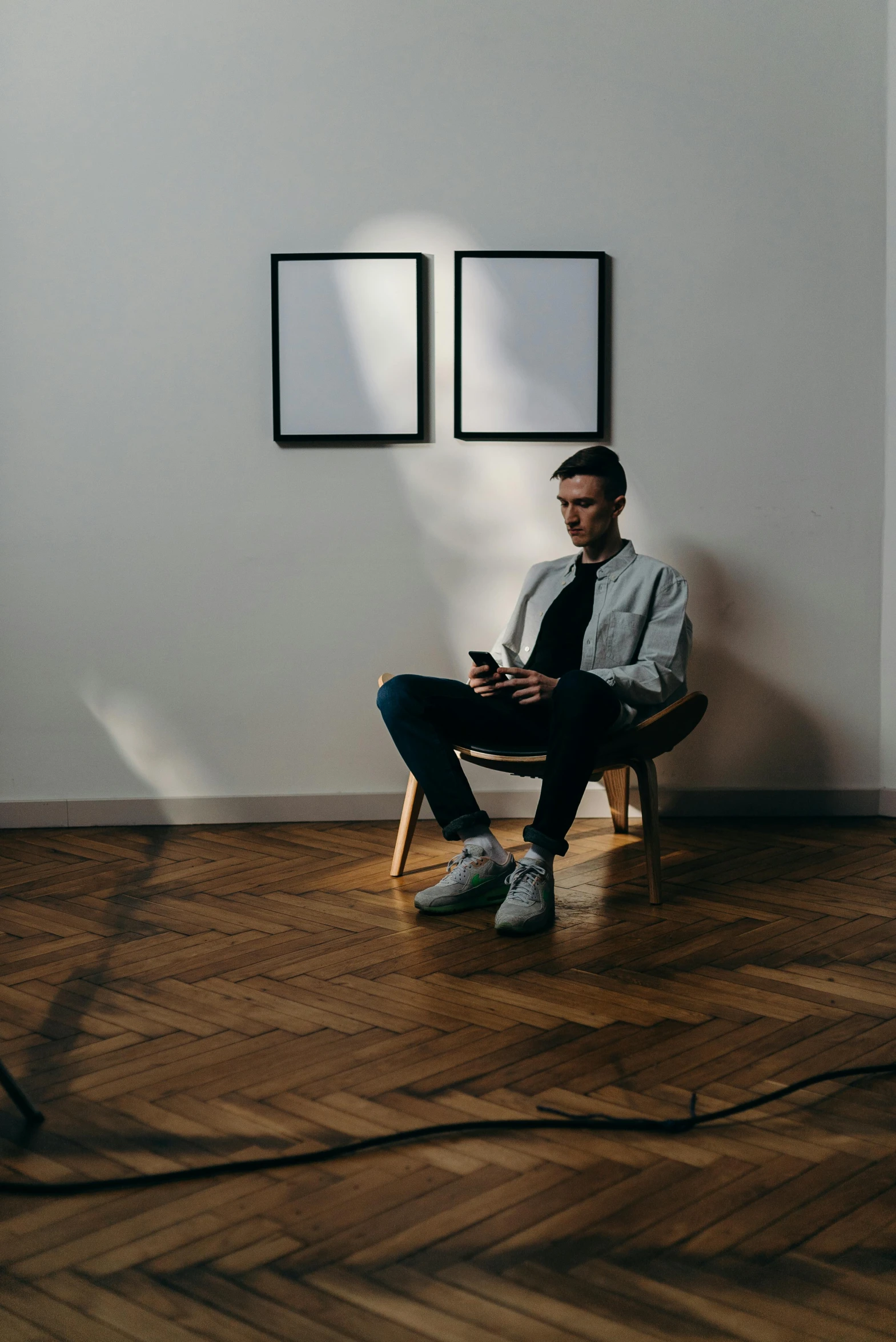 a man sitting in a chair in a room, connectivity, kacper niepokolczycki, thin young male, promo image