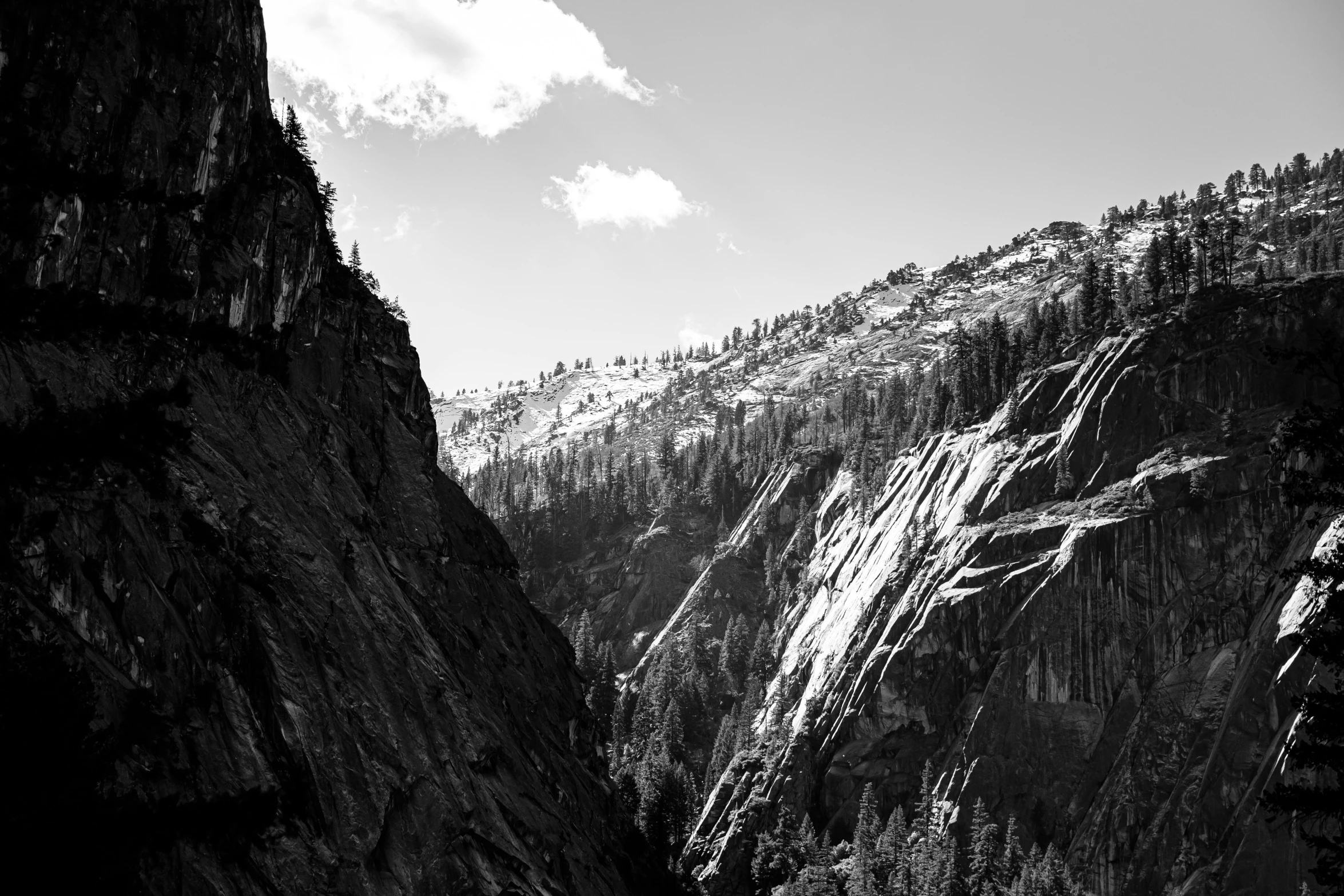 a black and white photo of a mountain, yosemite, canyon background, the mountain is steep, straight smooth vertical