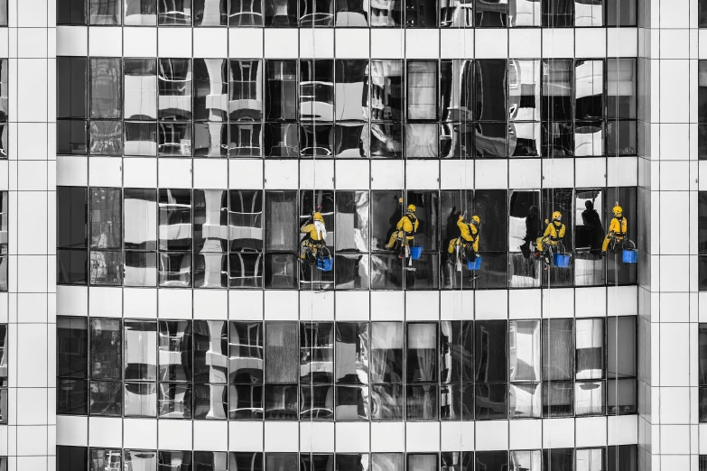 a black and white photo of a tall building, by Patrick Pietropoli, pexels, with yellow cloths, cyborgs working, cleaning future, black windows