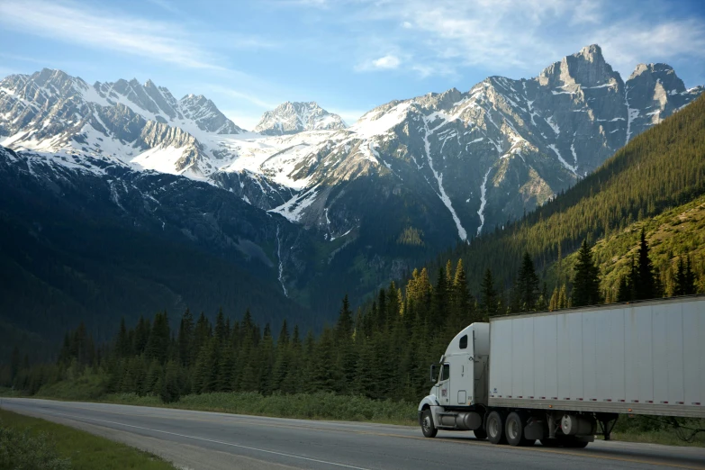 a truck driving down a road with mountains in the background, inspect in inventory image, extra crisp image, thumbnail, ansel ]
