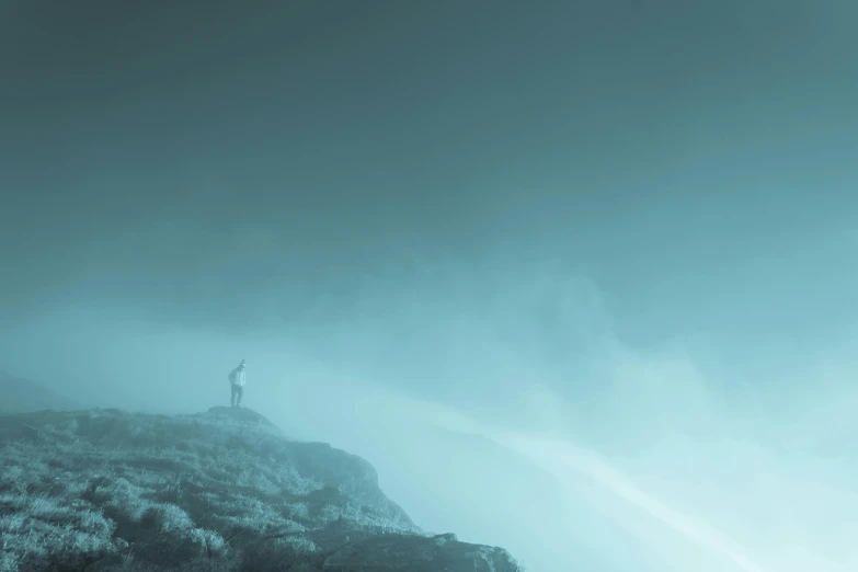 a person standing on top of a mountain on a cloudy day, inspired by jessica rossier, pexels contest winner, romanticism, cyan fog, mikko lagerstedt, foggy neon night, raging sea foggy