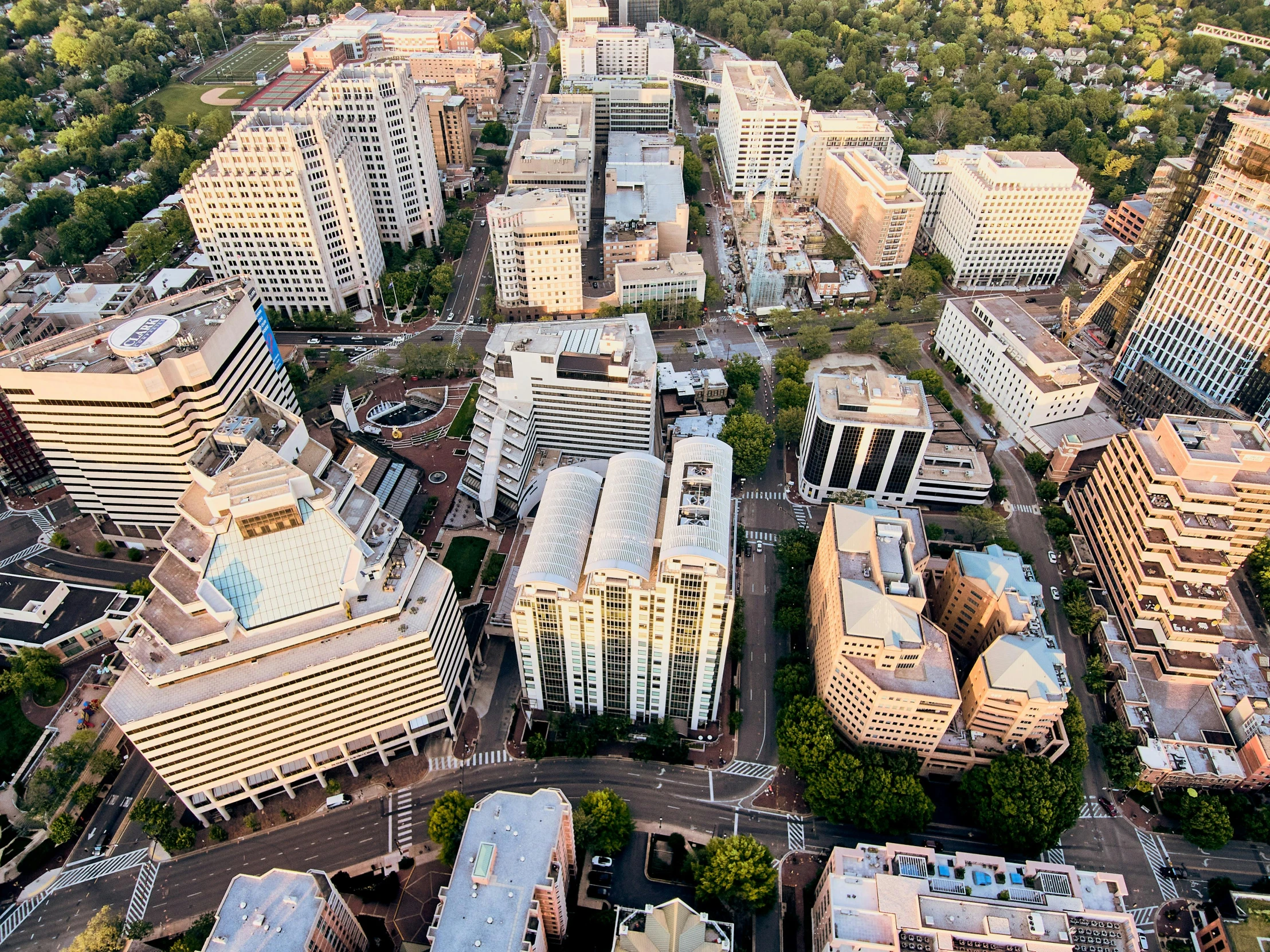 an aerial view of a city with tall buildings, by Jeffrey Smith, research complex, capital plaza, fan favorite, group photo