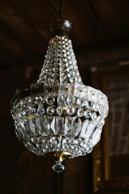 a crystal chandelier hanging from a ceiling, by Thomas Furlong, pexels, ornate spikes, early 2 0 th century, single light, side light