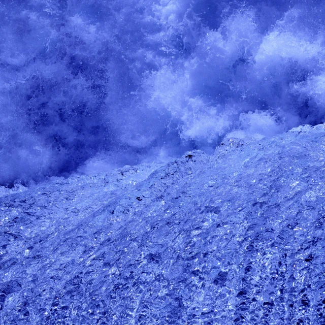 a man riding a snowboard down a snow covered slope, an album cover, inspired by Kaii Higashiyama, flickr, conceptual art, blue crystals, background image, turbulent water, jelly - like texture. photograph