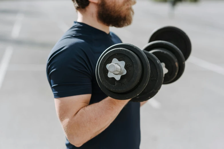 a man with a beard is holding a pair of dumbbells, by Niko Henrichon, pexels contest winner, half body cropping, exterior shot, mid riff, avatar image