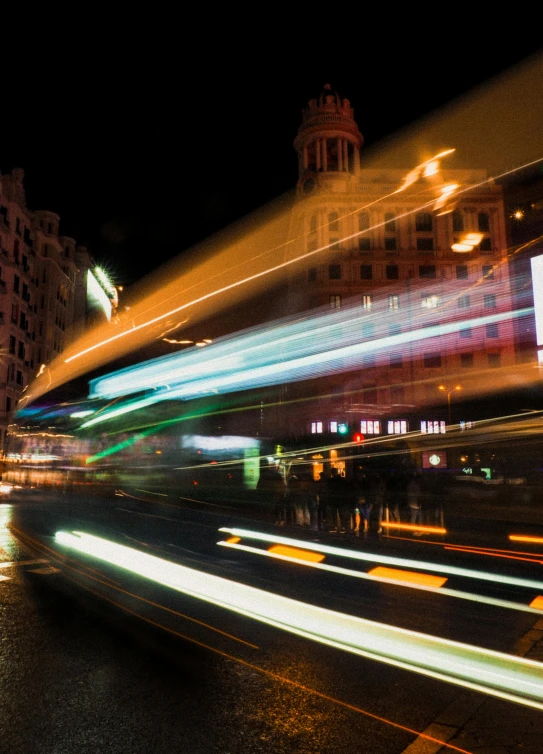 a blurry picture of a city street at night, trending on unsplash, visual art, madrid. extreme long shot, square, buses, high quality photo