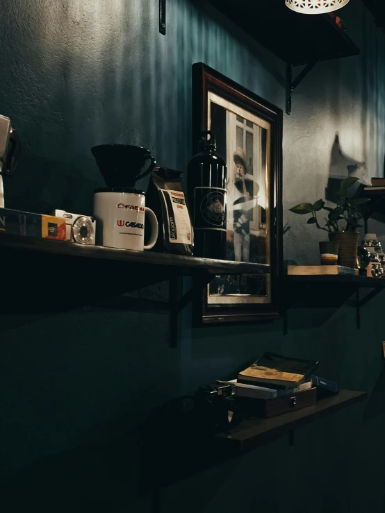 a man sitting at a table in a coffee shop, a still life, inspired by Elsa Bleda, unsplash contest winner, jar on a shelf, dark blue and black, standing in corner of room, detailed product image