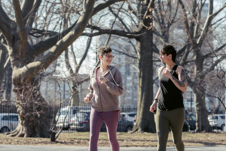 a couple of women standing on top of a skateboard, by Nina Hamnett, pexels, walking at the park, wearing fitness gear, avatar image, central park