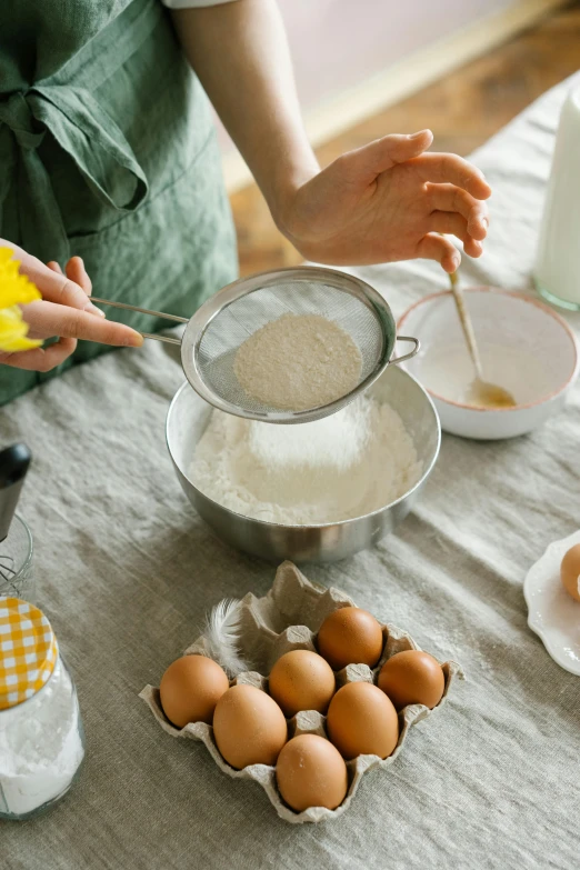 a woman in an apron mixing ingredients on a table, a still life, trending on pexels, square, an egg, banner, long