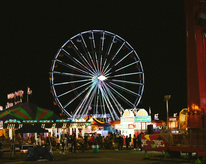 a carnival at night with a ferris wheel in the background, square, trending on, eyecandy, multiple stories