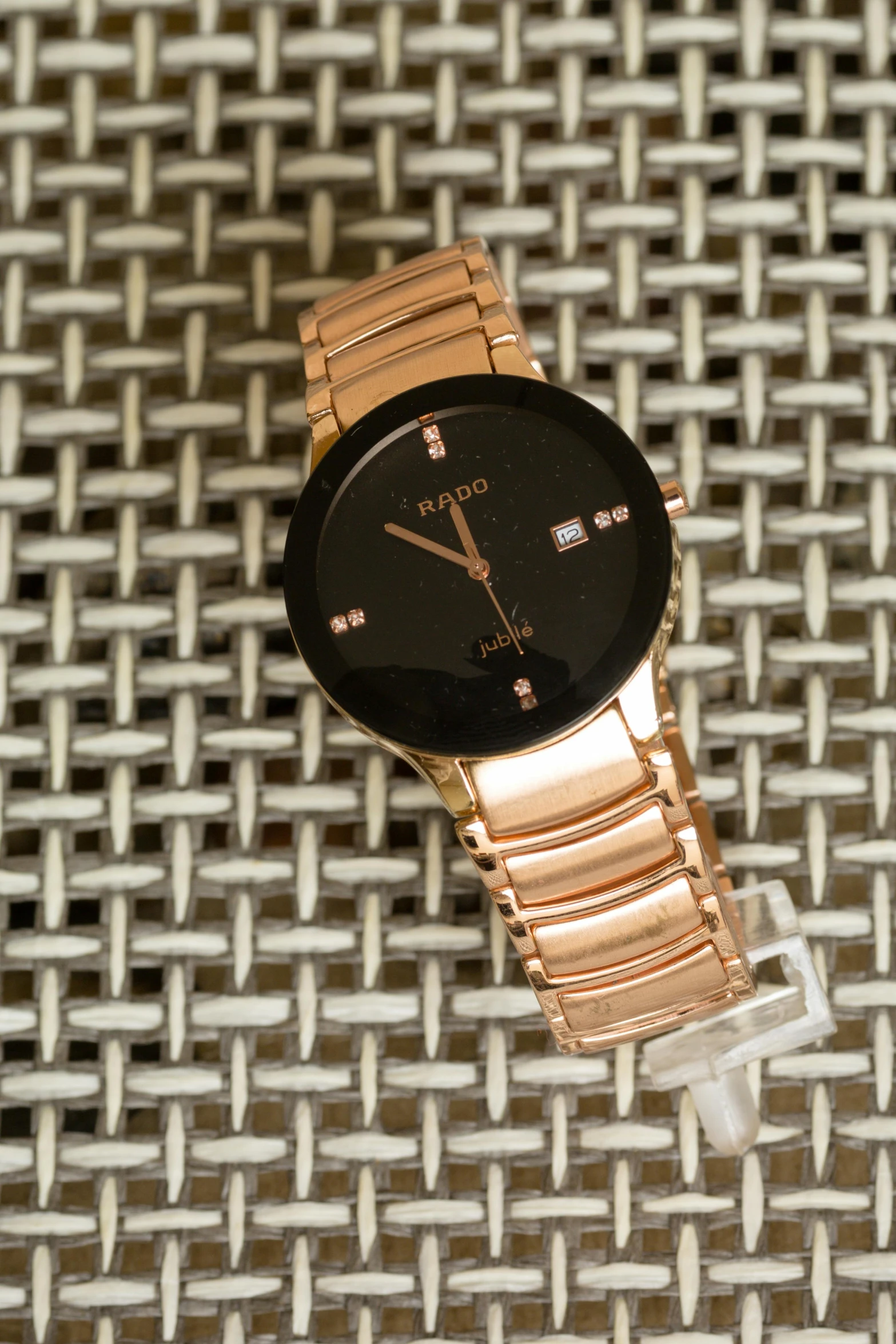 a close up of a watch on a table, by Alfred Jensen, rose gold, promo image, thumbnail, bling