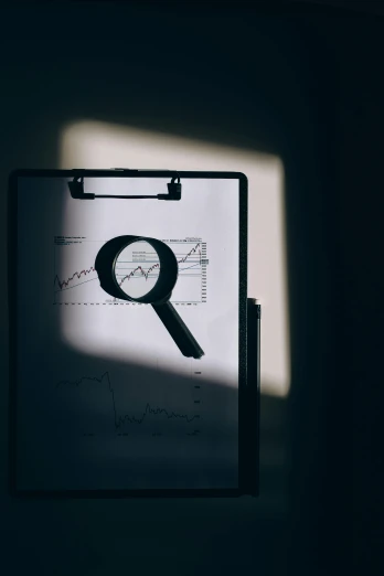 a clipboard with a magnifying glass on it, trending on unsplash, on the qt, showing curves, exponential, back lit