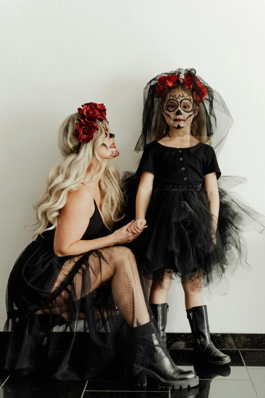 a woman sitting next to a little girl in a black dress, sugar skull, tulle and lace, black on black, slide show