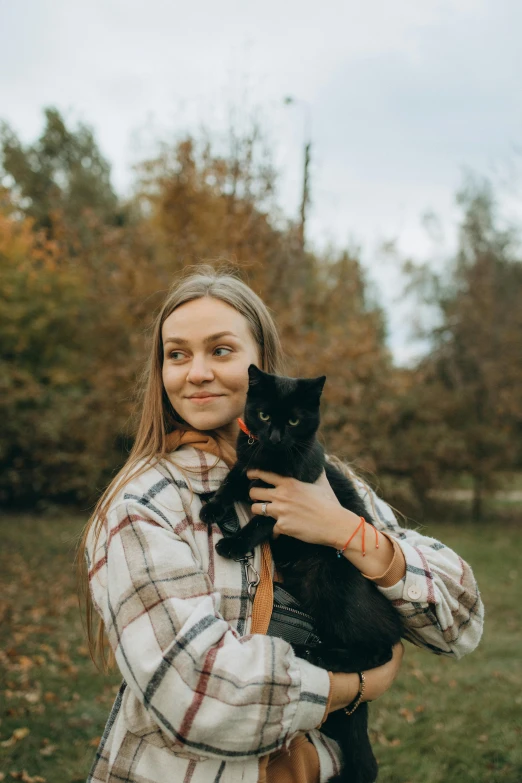 a woman holding a black cat in her arms, by Julia Pishtar, pexels contest winner, wearing a flannel shirt, greta thunberg, maxim shirkov, square