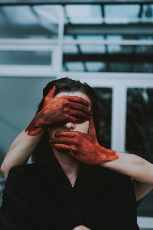 a woman covering her face with her hands, pexels contest winner, visual art, blood on his face, red birthmark, muffled colours, instagram post