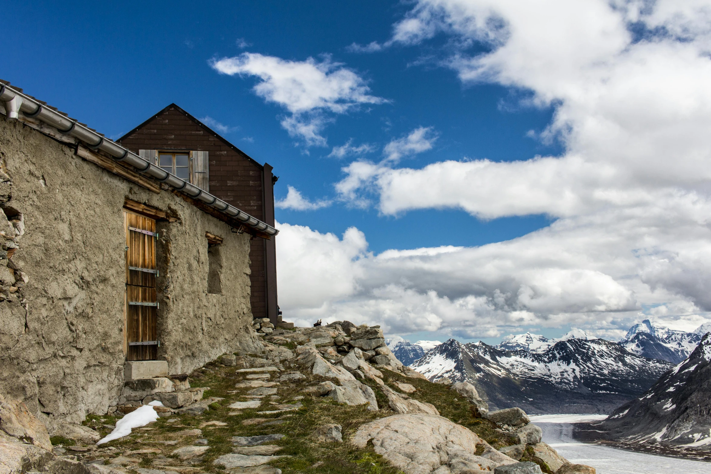 a stone building sitting on top of a mountain, by Peter Churcher, pexels contest winner, renaissance, chalet, high elevation, 1940s photo, album cover