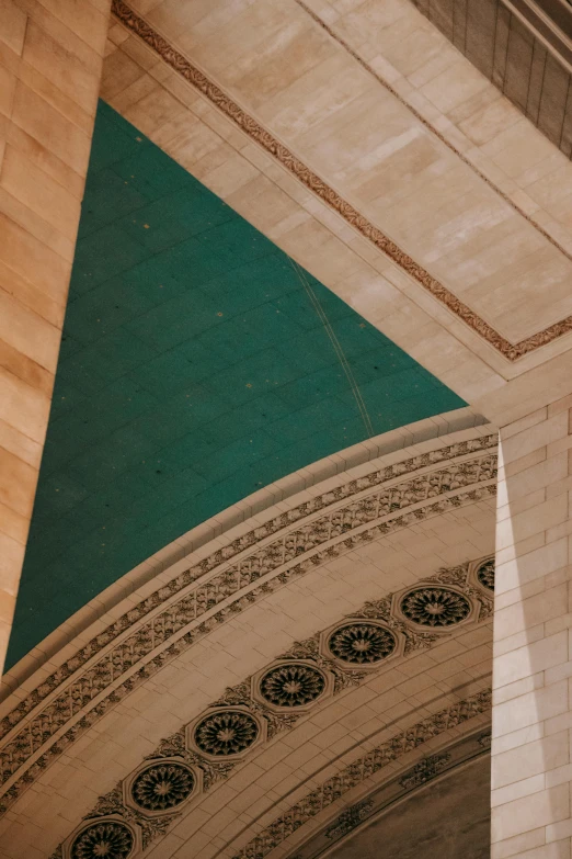 a clock that is on the side of a building, an album cover, inspired by Art Green, trending on unsplash, neoclassicism, complex ceiling, green cloak, high arches, nyc