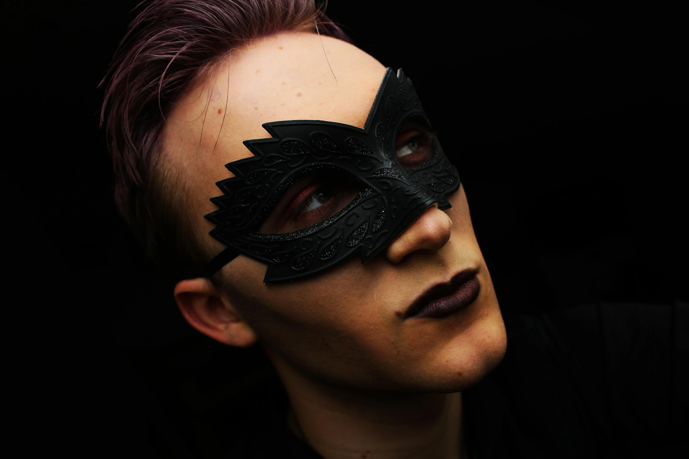 a close up of a person wearing a mask, inspired by Hedi Xandt, pexels contest winner, androgynous vampire, ryan renolds as batman, non-binary, sinister pose