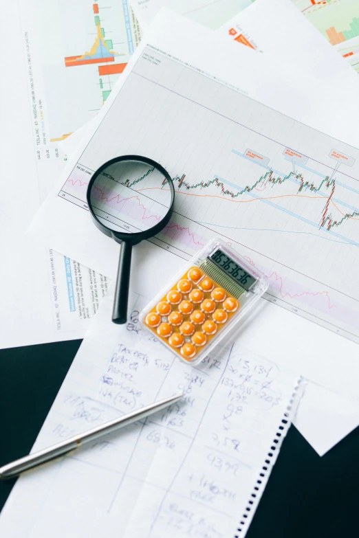 a pile of papers with a calculator and a magnifying glass, trending on unsplash, analytical art, displaying stock charts, thumbnail, flat lay, multiple stories