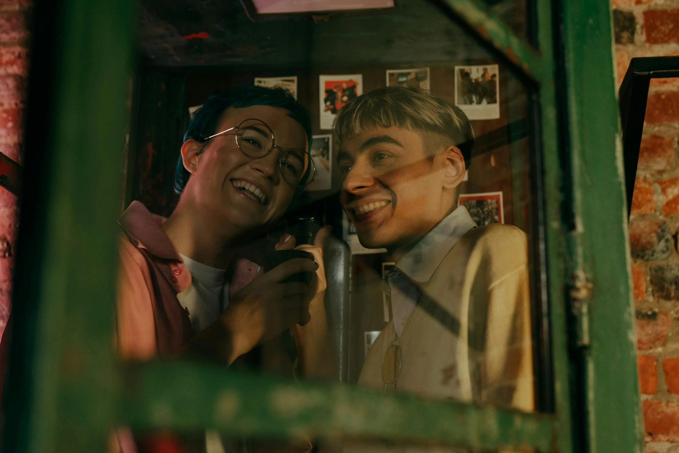 a couple of men standing next to each other, trending on pexels, 8 0 s asian neon movie still, inside in a glass box, lesbians, selfie