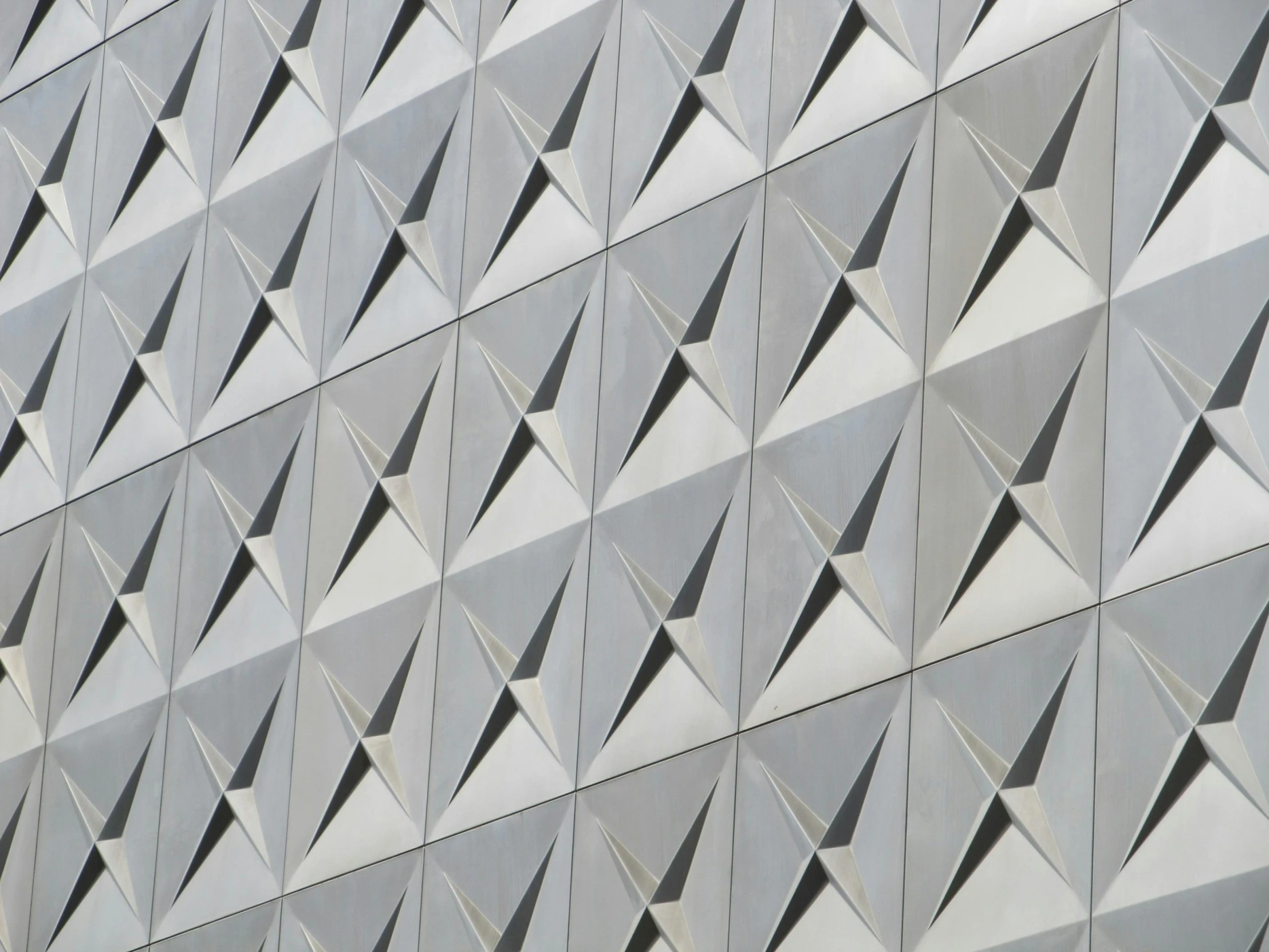 a close up of a building with a clock on it, inspired by David Chipperfield, pexels contest winner, brutalism, fractal details diamond skin, futuristic marrakech, large triangular shapes, aluminum