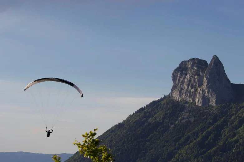 a person that is in the air with a parachute, pexels contest winner, figuration libre, mountain in background, herzog de meuron, slide show, viewed from a distance