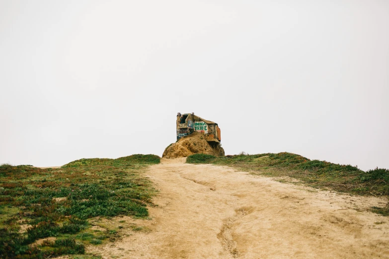 a tractor sitting on top of a dirt road, by Jessie Algie, unsplash, process art, sutro tower in san francisco, rustic stone cabin in horizon, sand piled in corners, 2 5 6 x 2 5 6 pixels