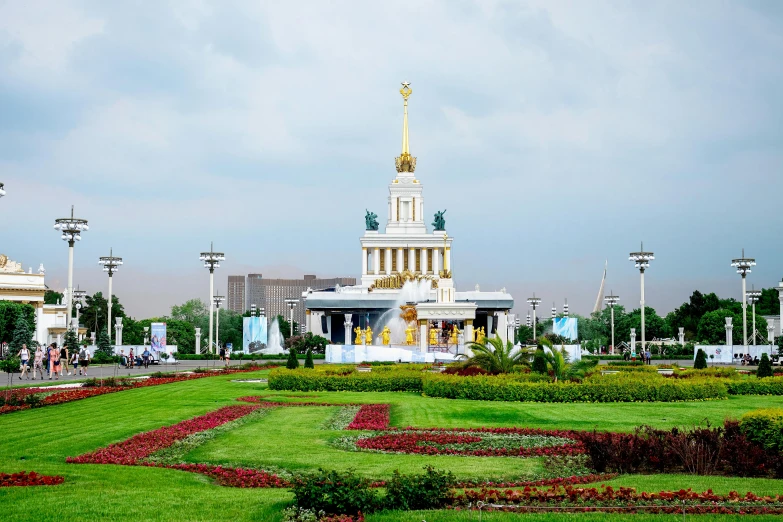 a large building with a clock tower on top of it, a statue, by Julia Pishtar, pexels contest winner, socialist realism, a park, vostok-1, the grand temple of flowers, panorama