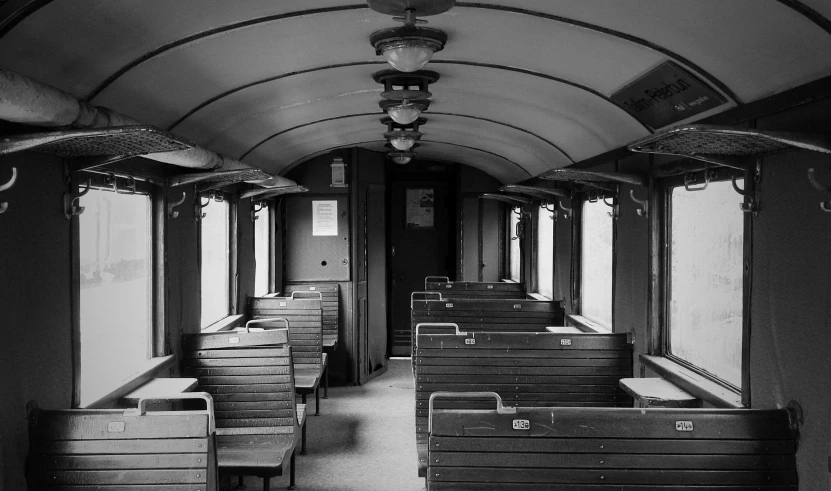 a black and white photo of a train car, by Lucia Peka, pixabay, 1 9 2 0 s furniture, ffffound, clean and empty, romanian