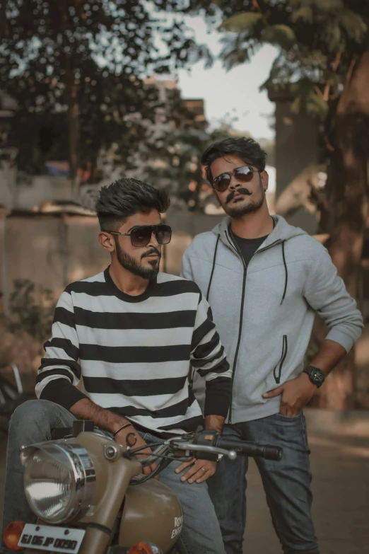 two men standing next to each other on a motorcycle, by Max Dauthendey, pexels contest winner, jayison devadas style, wearing shades, college, profile pic