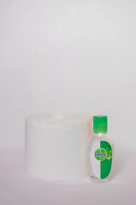a bottle of hand sanitizer next to a roll of toilet paper, by Orshi Drozdik, dribble, dau-al-set, plain background, clover, medium - shot, cecco bravo