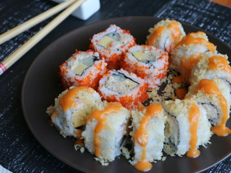 a plate of sushi and chopsticks on a table, inspired by Maki Haku, unsplash, mingei, gray and orange colours, a blond, grain”