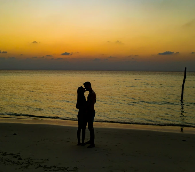 two people standing on a beach at sunset, pexels contest winner, romanticism, making out, jamaica, profile image, long distance photo