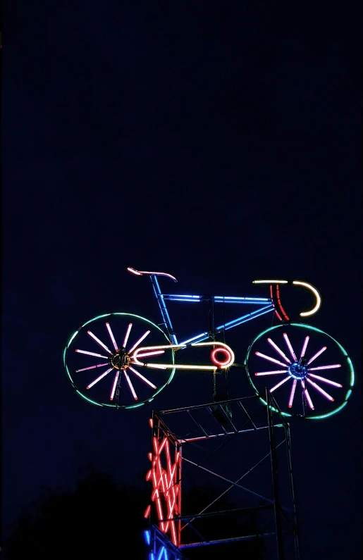 a neon sign with a bicycle on top of it, kinetic art, taken with sony alpha 9, ( ( photograph ) ), ilustration, sports photo