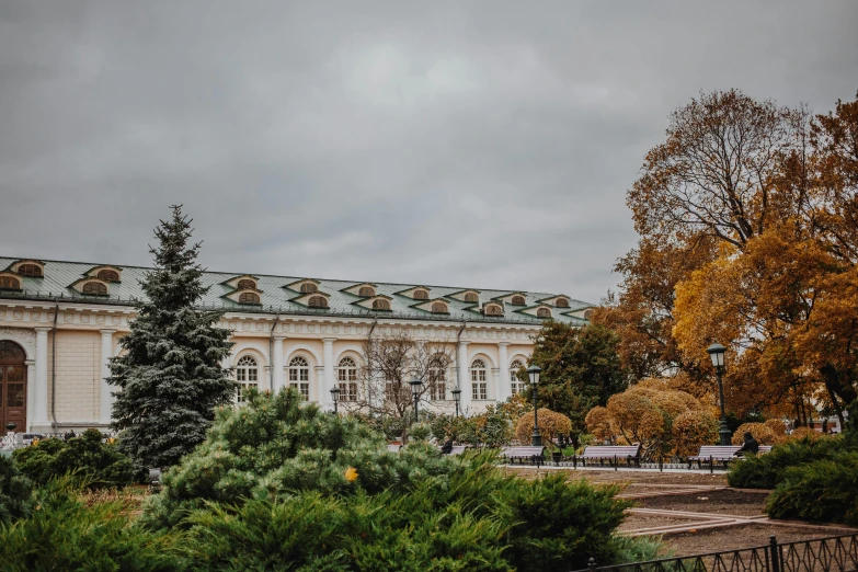 a large white building surrounded by trees and bushes, a photo, pexels contest winner, rococo, moscow, autum garden, cloudy day, rectangle