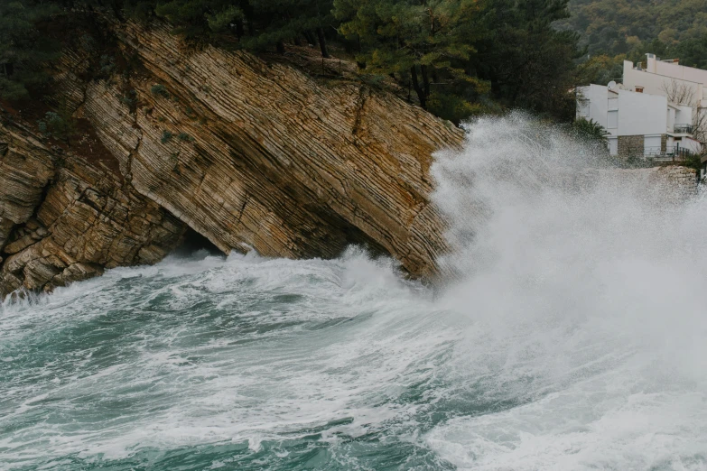 a man riding a surfboard on top of a wave, pexels contest winner, romanticism, geological strata, abel tasman, heavy rainfall, falling off a cliff