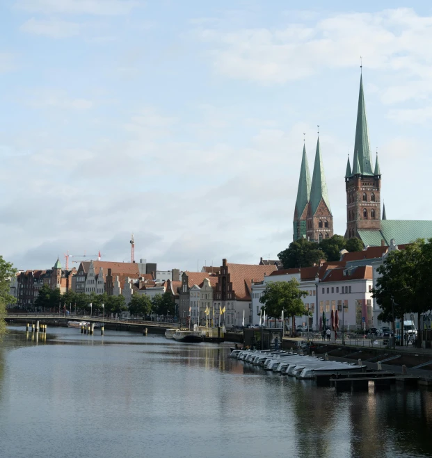 a large body of water with a church in the background, by Lorentz Frölich, pexels contest winner, hurufiyya, tall spires, waterway, dunwall city, set in ww2 germany