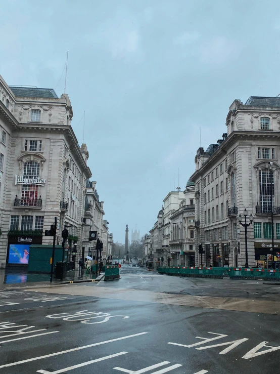 a street filled with lots of traffic next to tall buildings, an album cover, pexels contest winner, renaissance, on a wet london street, neoclassical architecture, empty streetscapes, obelisks