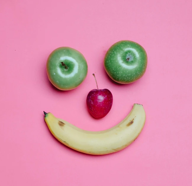 a smiley face made out of apples and a banana, pexels, pink, 🎀 🧟 🍓 🧚, bright happy atmosphere, profile pic
