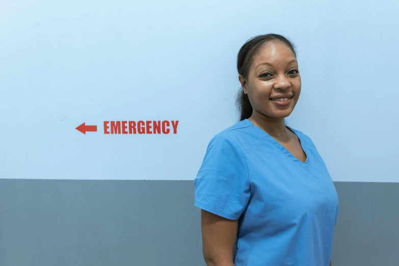 a woman standing in front of an emergency sign, pexels contest winner, hospital ward, photo of a black woman, extra crisp image, profile image