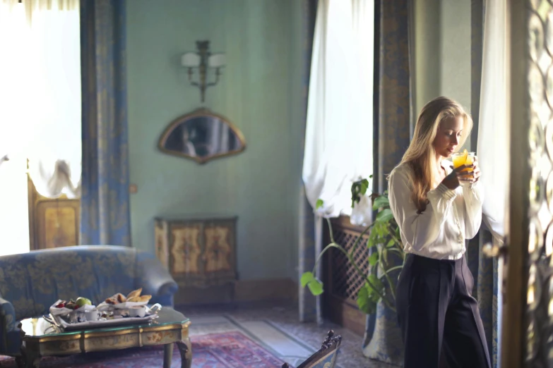 a woman standing in a living room holding a flower, a portrait, pexels contest winner, romanticism, checking her cell phone, italian looking emma, filmstill, lush surroundings