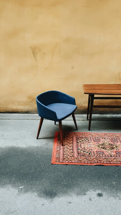 two chairs and a table in front of a yellow wall, by Carey Morris, unsplash contest winner, navy blue carpet, brown red blue, 15081959 21121991 01012000 4k, persian carpet