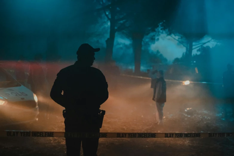 a man standing in front of a police car, by Adam Marczyński, pexels contest winner, realism, neon fog, police tape, still from riverdale, medium shot of two characters