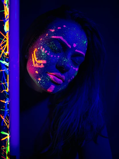 a woman with fluorescent paint on her face, a portrait, by Julia Pishtar, pexels contest winner, holography, black light velvet poster, profile image, neon sparkles everywhere, neon edges on bottom of body
