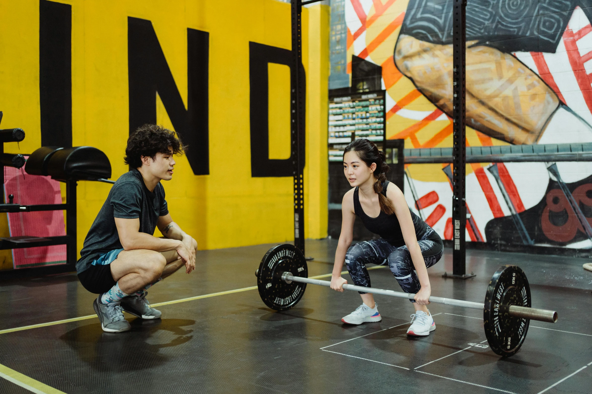 a couple of people in a gym with a barbell, pexels contest winner, process art, background image, hoang long ly, ground level shot, scandy and arender