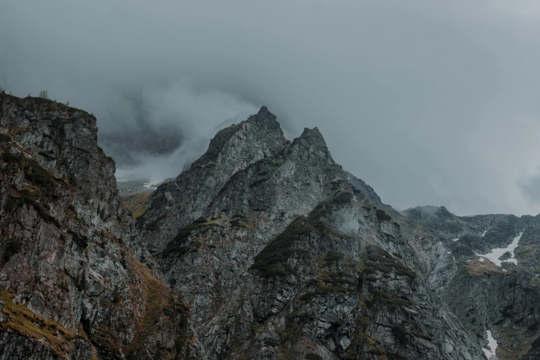 a group of people standing on top of a mountain, an album cover, by Adam Marczyński, pexels contest winner, baroque, overcast gray skies, “ aerial view of a mountain, crib goch!!!!!!!!!!! ridge, high textured