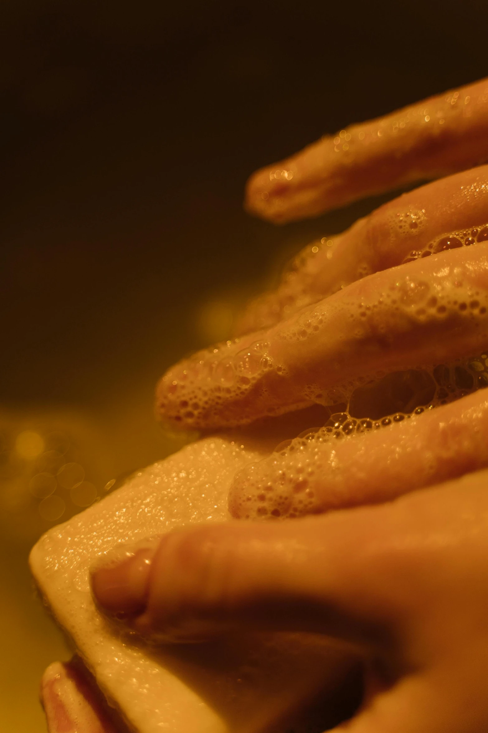 a person washing their hands with a sponge, inspired by Elsa Bleda, molecular gastronomy, still from film, low light, baking french baguette