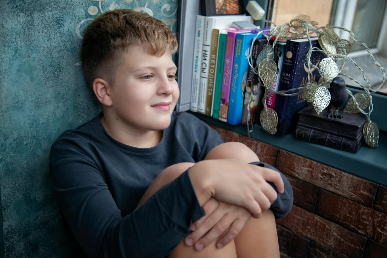 a young boy sitting in front of a window, a portrait, by Anna Findlay, pexels contest winner, male teenager, sitting on a store shelf, 15081959 21121991 01012000 4k, lachlan bailey